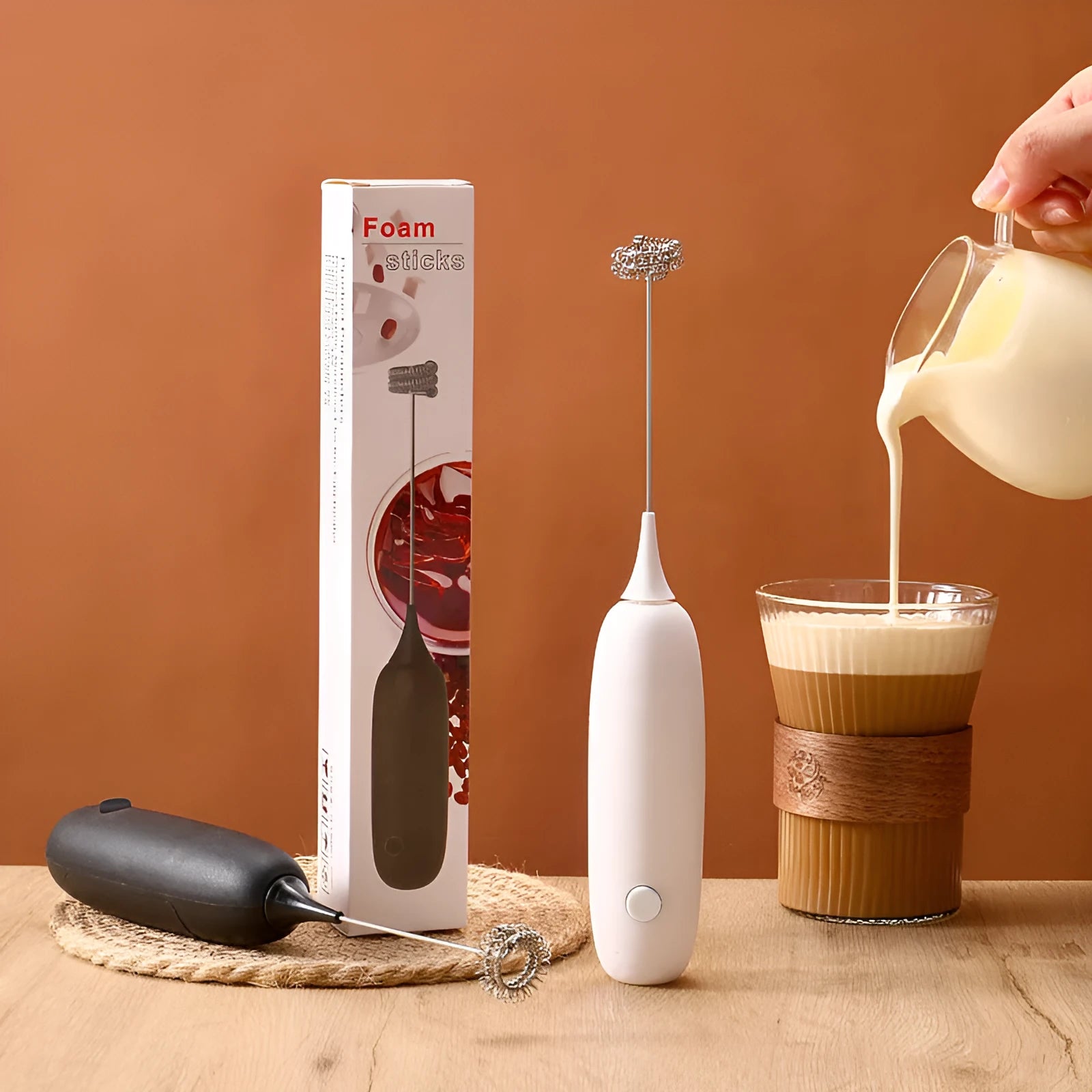 Black and white handheld electric milk frother blender for coffee preparation