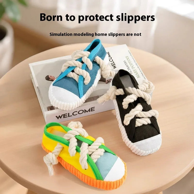 A rock yellow plastic dog chew toy shaped like a slipper, designed for biting and making sound.