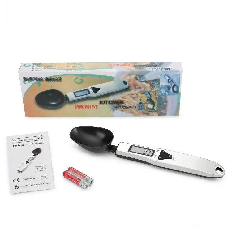 Smart digital measuring spoon with integrated display showing weight, next to AAA batteries.