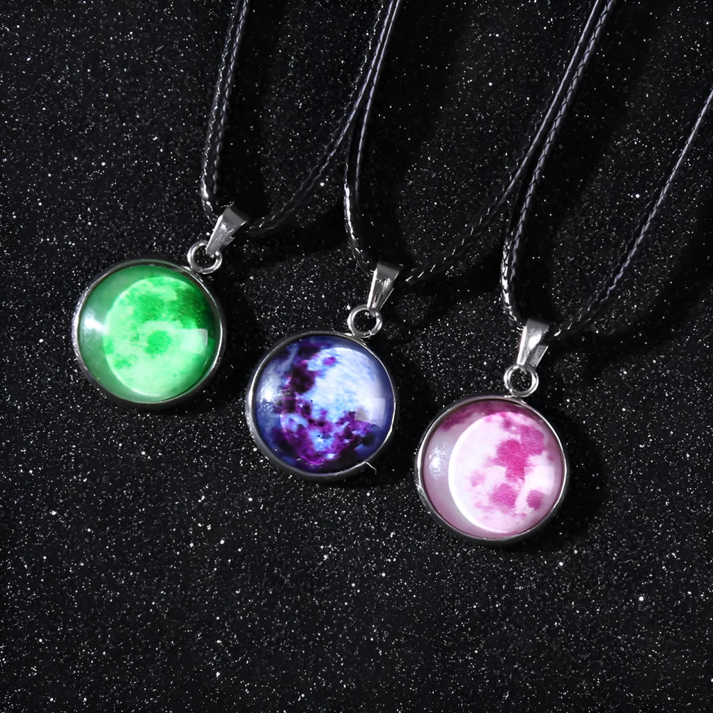 Luminous moon and constellation glass pendant on a silver alloy necklace chain with an extension piece.