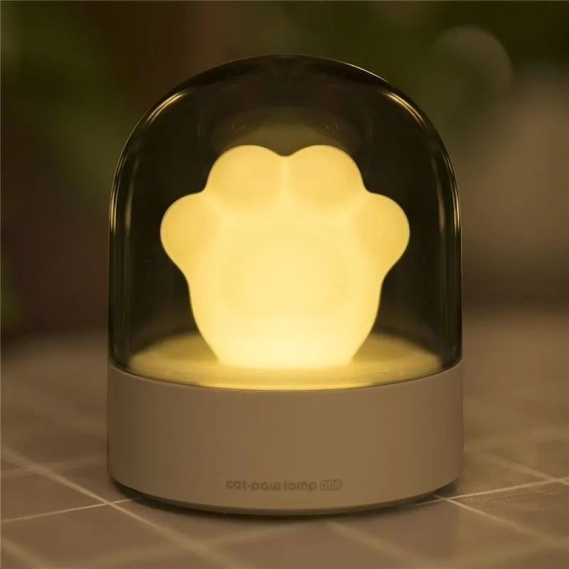 Grey cat paw USB charging music box night light with adjustable brightness on wooden desk