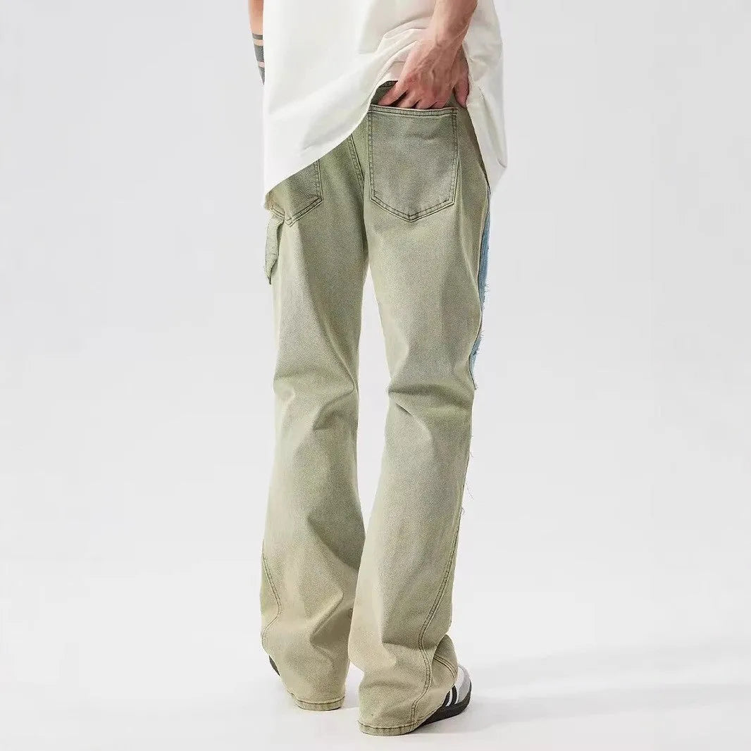 Yellow and blue retro patchwork jeans with splash-ink damaged design and zip fly.