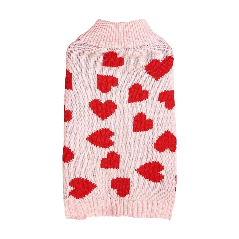 Red dog jumper with a white love heart and bow design on a small dog.