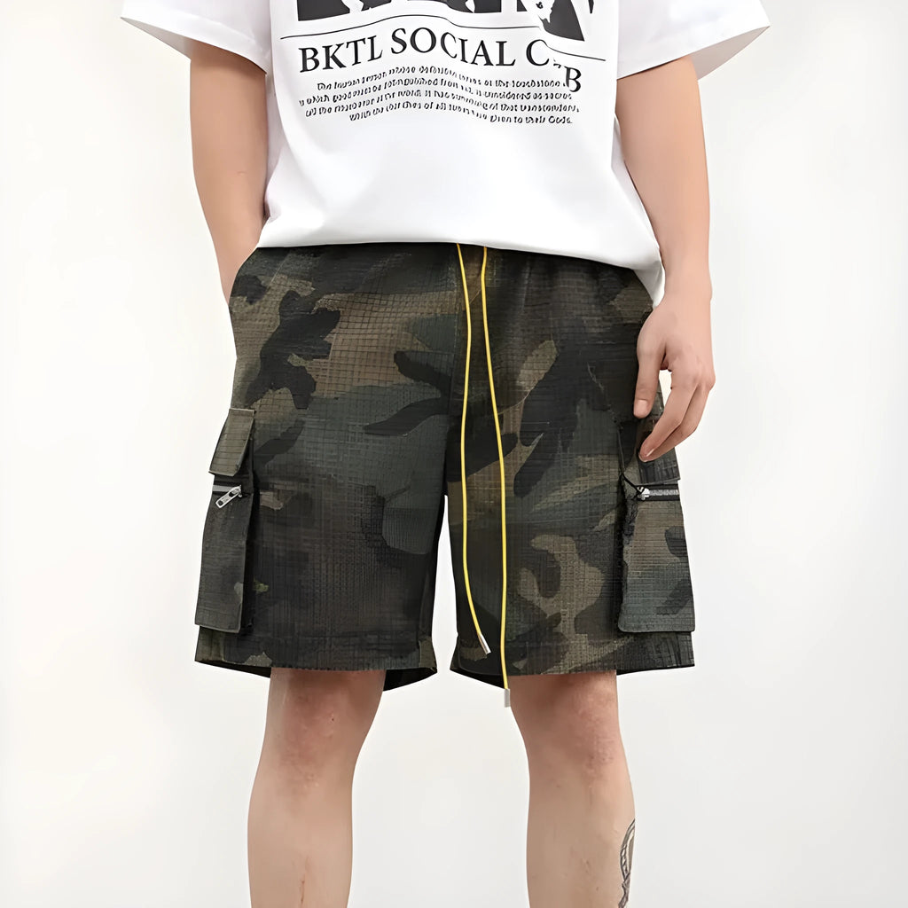 Men's camouflage cotton blend cargo shorts with multiple pockets, shown in a loose cropped fit.