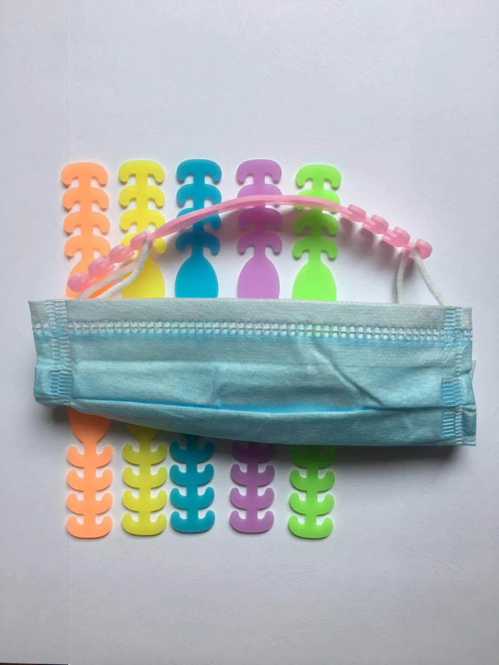 Eight silicone protective buckles in different colours for cable organisation