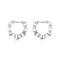 Pair of sterling silver geometric hoop earrings with round elements and electroplated finish