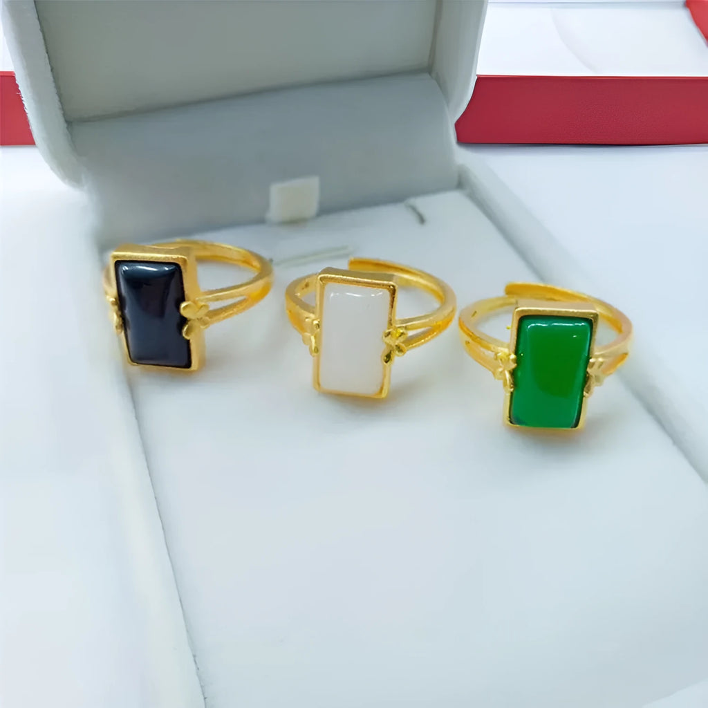 Adjustable brass gold-plated ring with a long green gemstone in a national style setting.
