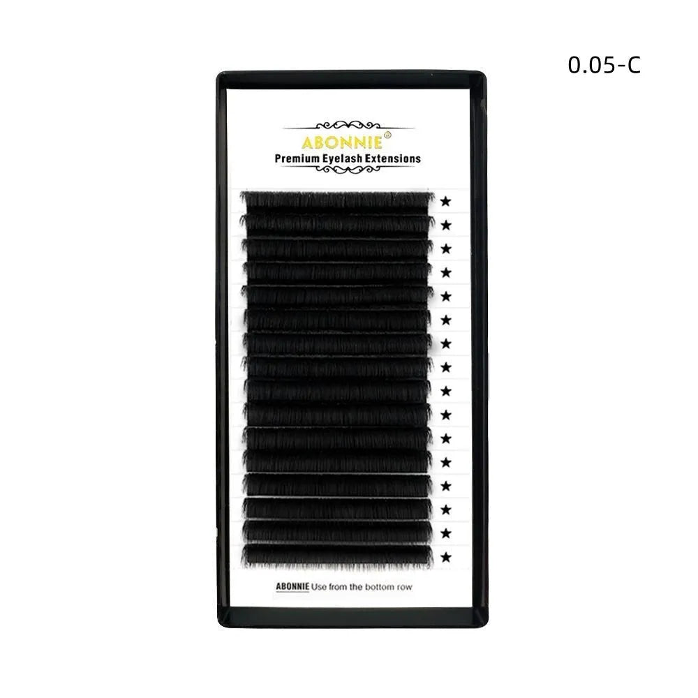 A 16-row dense tray of matte round wool false eyelashes made from mink hair, showing variations in length.