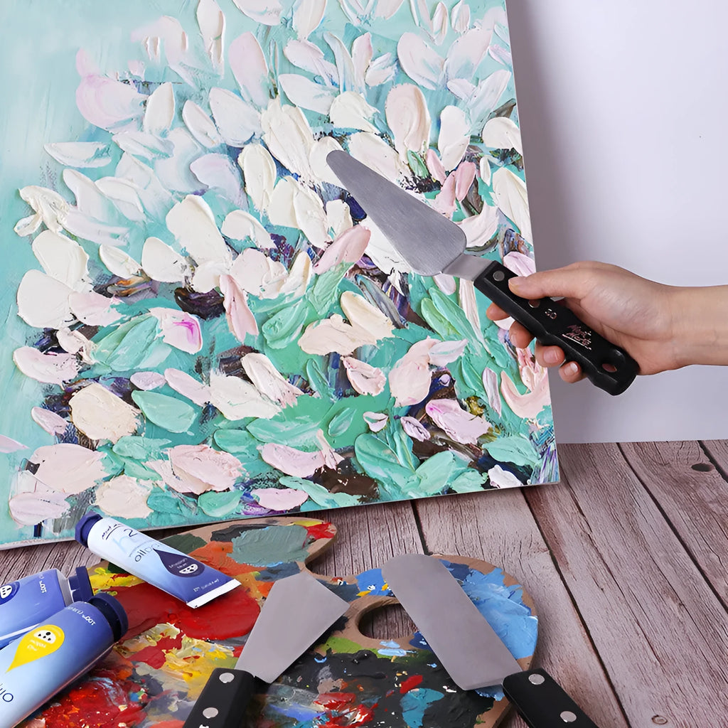 Three stainless steel palette knives for oil and acrylic painting with different blade sizes.