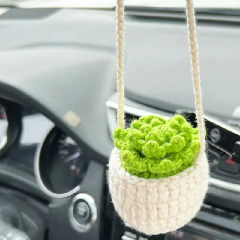 Green and white knitted wool car plant decoration with 8cm base and hanging rope.