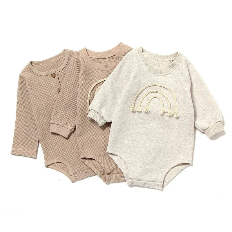 Long sleeve waffle cotton baby romper in neutral colour on hanger