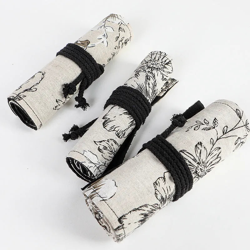 Black Peony printed canvas pencil roll bag open to show 72 holes for pens and pencils