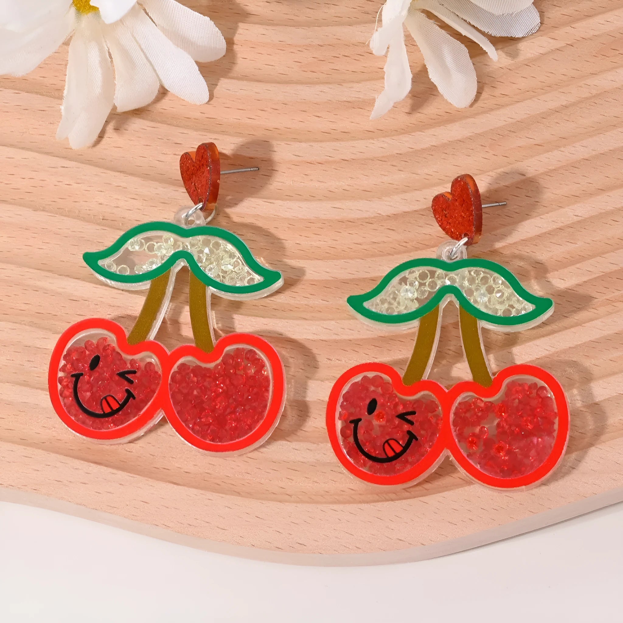 Colourful acrylic earrings with realistic fruit and dessert charms including cherry, strawberry, and ice cream.
