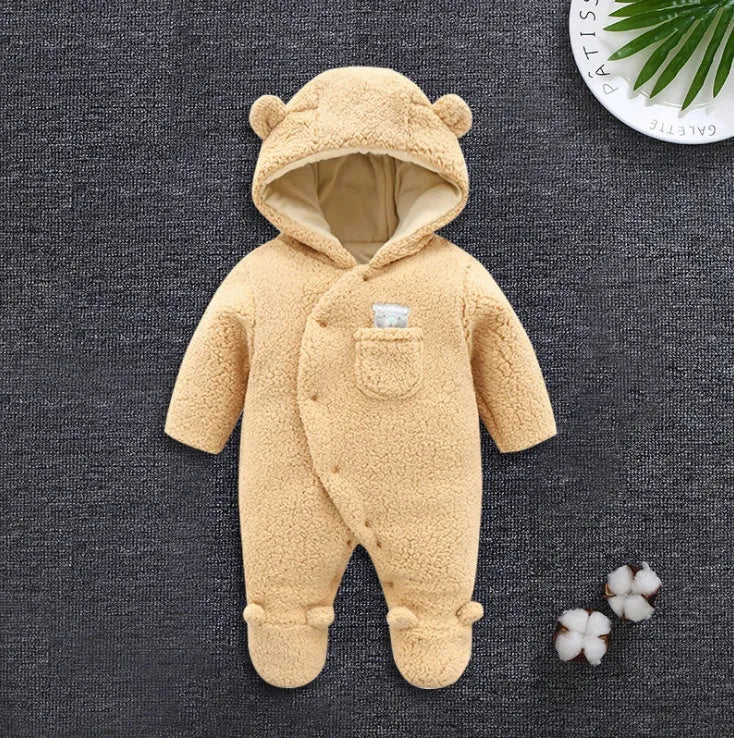 Baby wearing white cotton padded romper with lamb design and feet covers