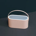 Portable pink and white beauty makeup mirror with storage box.