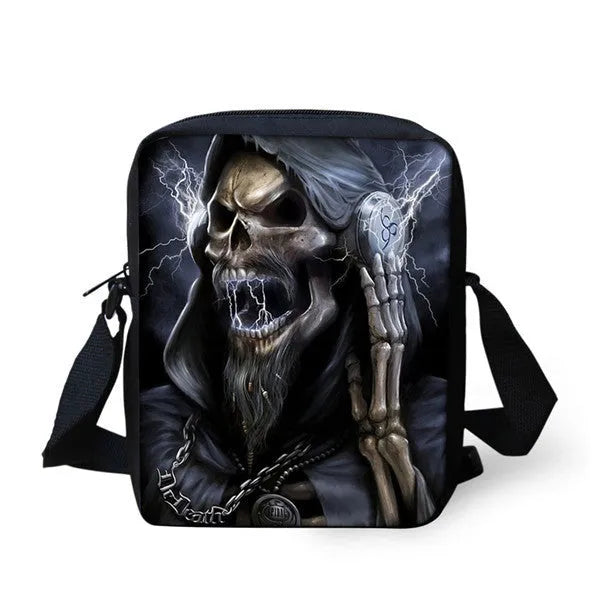 A medium-sized black children's messenger bag with a white skull print, showing double shoulder straps and a front zipper pocket.