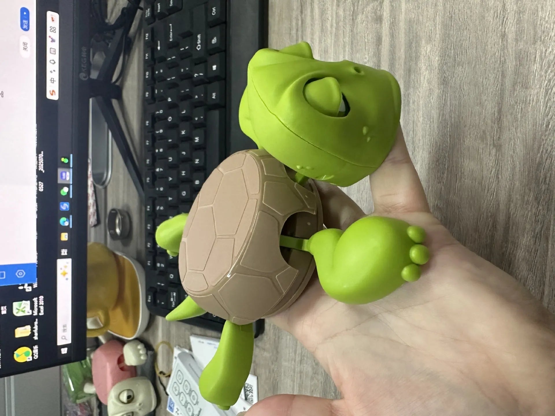 Turtle-shaped ABS plastic coaster in light green colour on table