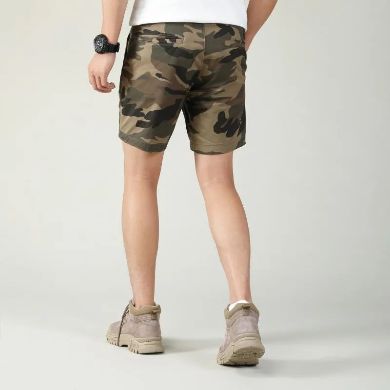 Youth cotton workwear shorts in camouflage green pattern with mid waist and zip fly.
