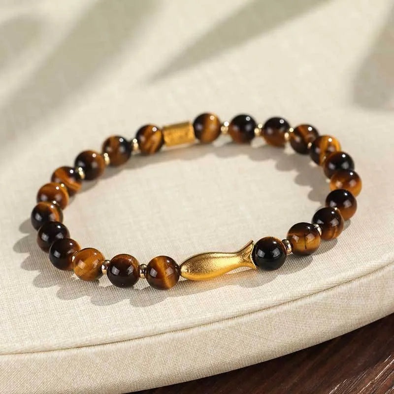 Handmade women's bracelet with tiger eye gemstone beads carved into small fish designs