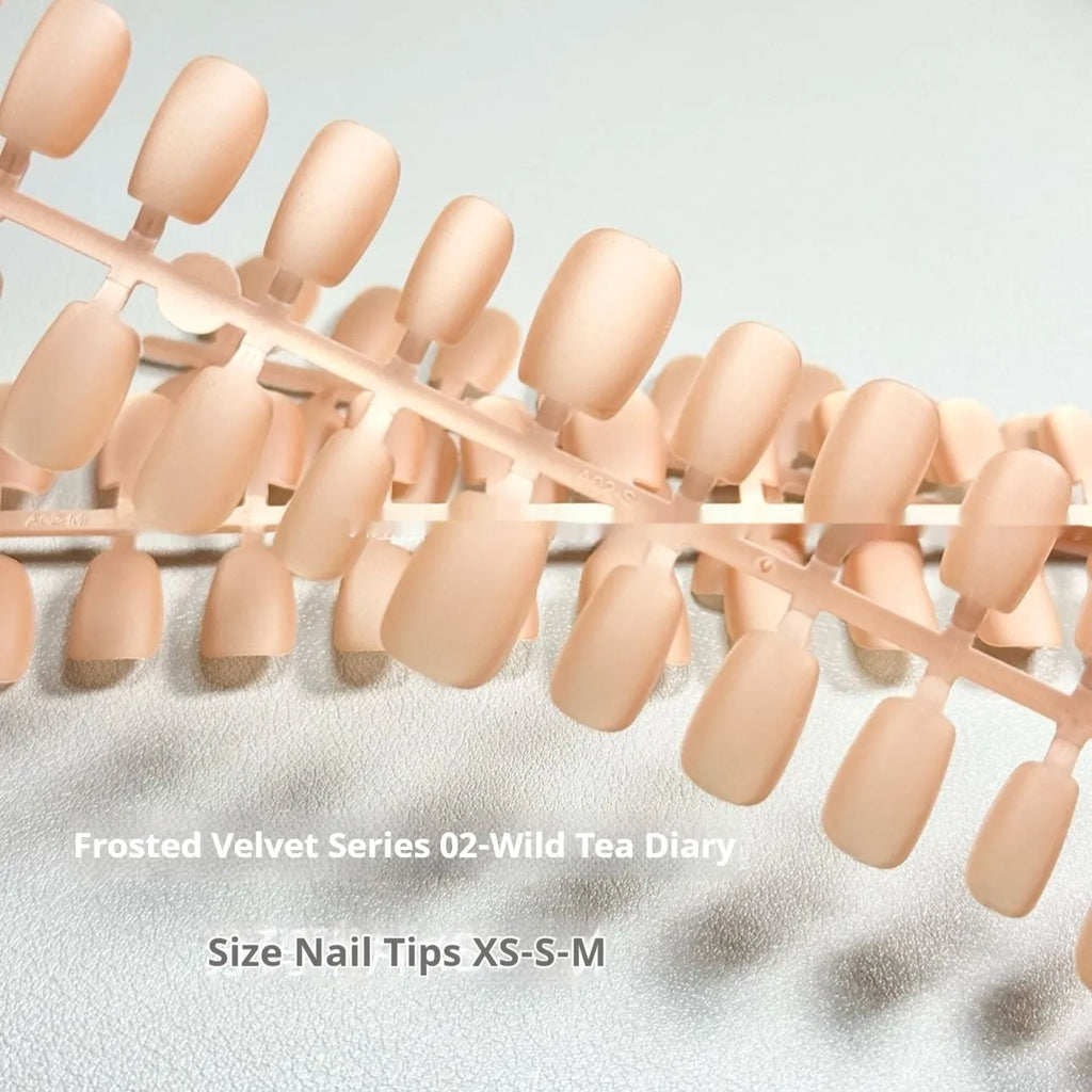 Set of velvet frosted cat's eye aurora effect false nails in short ladder sizes XS, S, and M on a white background.