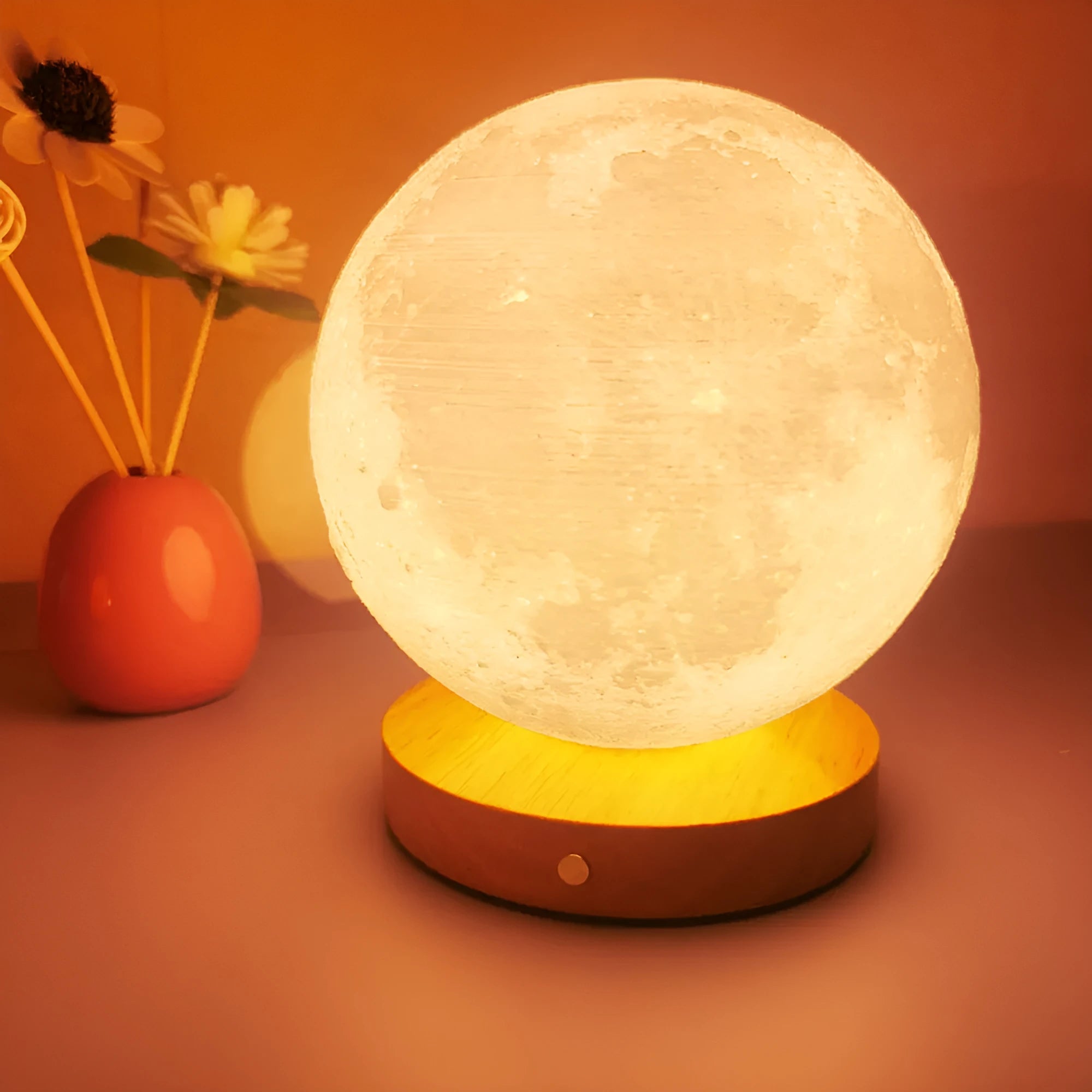 Rotating moon night light on wooden base showing three colour settings