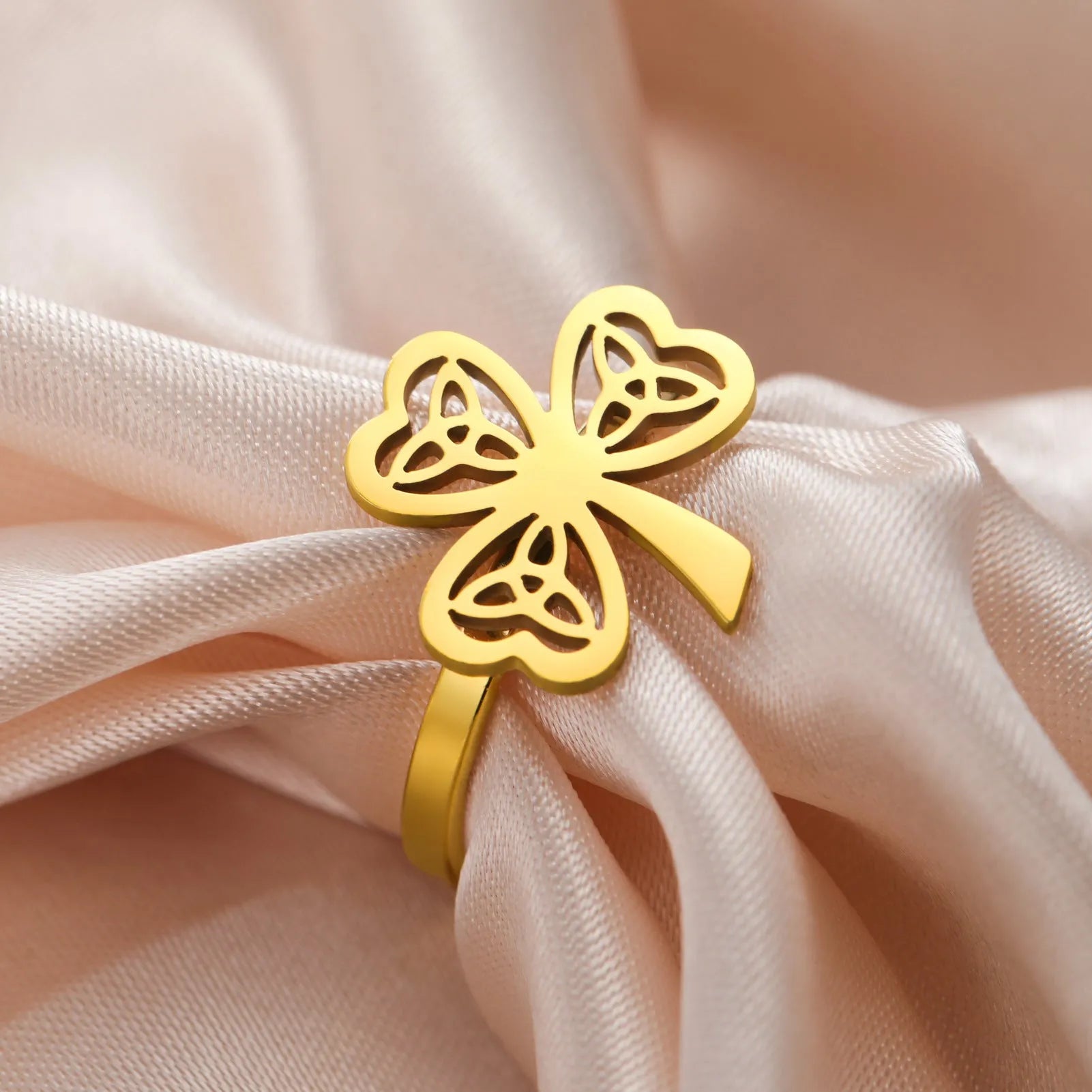 Women's hollow stainless steel fashion ring in gold or steel colour on a size chart.