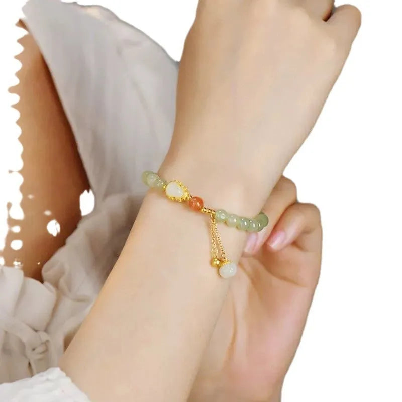 Qingshui jade bracelet with gold plated gourd charm and fu character pendant on adjustable cord