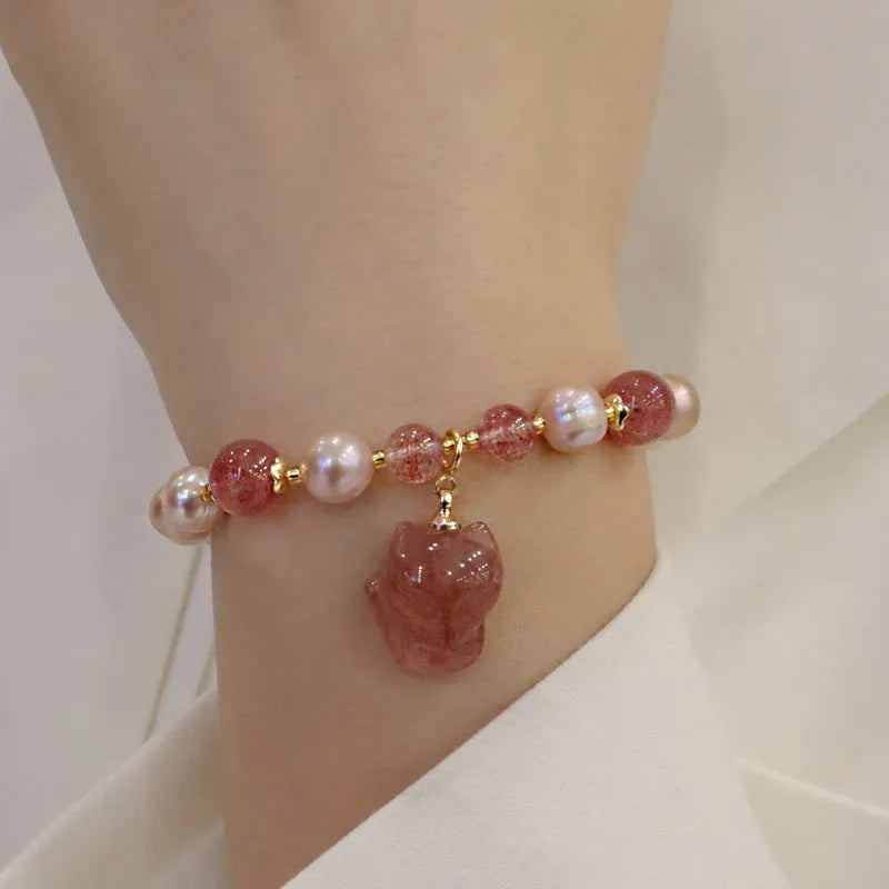 Light pink freshwater pearl bracelet with silver fox charm and strawberry quartz detail on adjustable strand