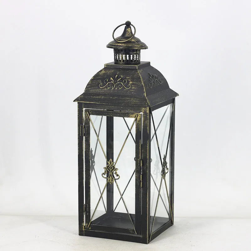 European-style black wrought iron floor-standing storm lantern with tempered glass panels.