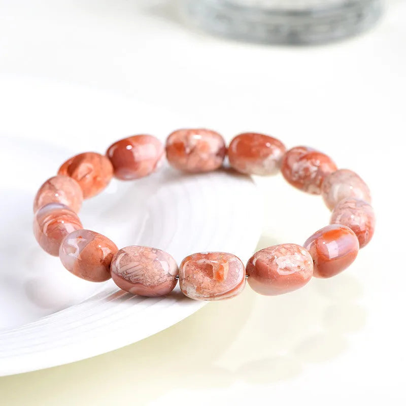 Original design agate bracelet with cherry blossom colour barrel beads and Ruyi charm.
