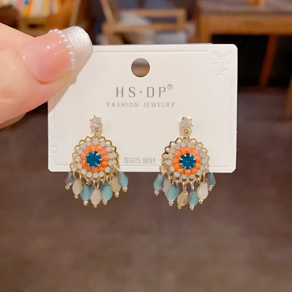 Round crystal tassel earrings with diamond embedded design and thick gold plating in blue or purple colour options