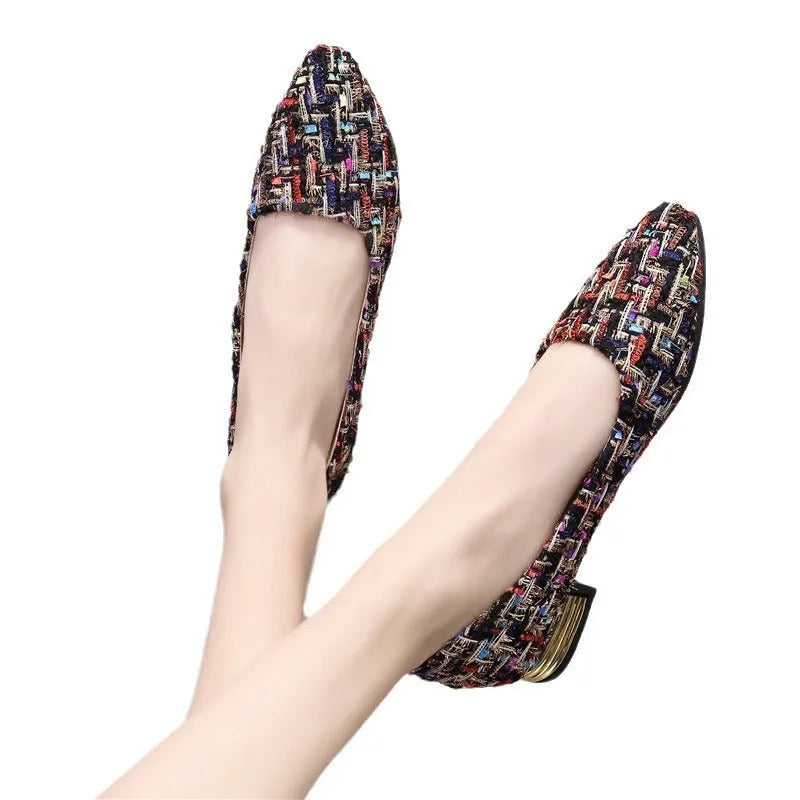 Women's black and white canvas flats with pointed toe and lace-up design