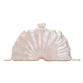 Acrylic shell-shaped clutch bag in champagne colour with chain detail on solid background