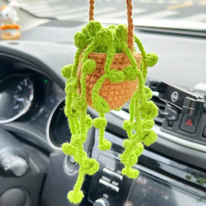 Green and white knitted wool car plant decoration with 8cm base and hanging rope.
