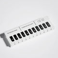 Black and white piano-shaped plastic temporary parking sign for vehicle dashboard