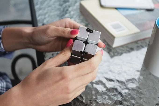 Zinc alloy infinity cube fidget toy in black finish showing rotating cube mechanism