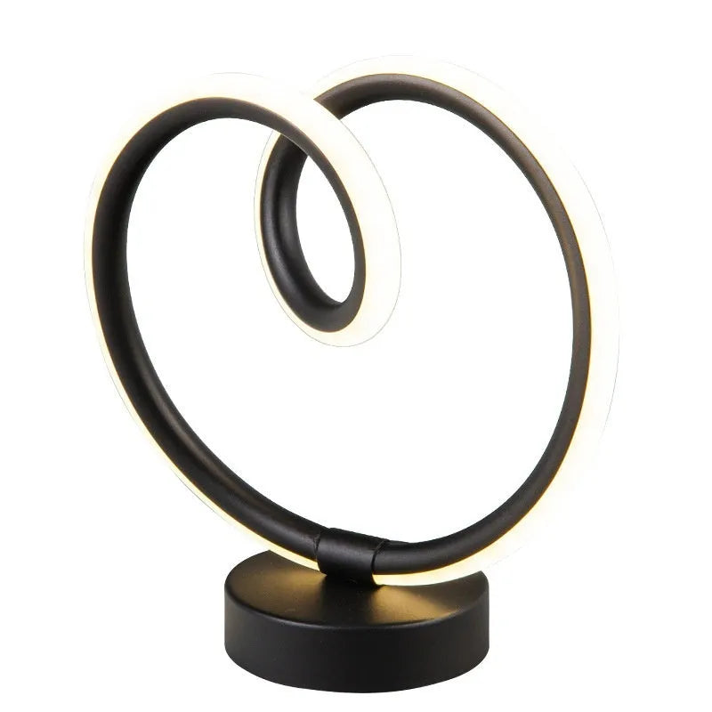 Black musical note shaped Bluetooth LED night light with remote control on a bedside table.
