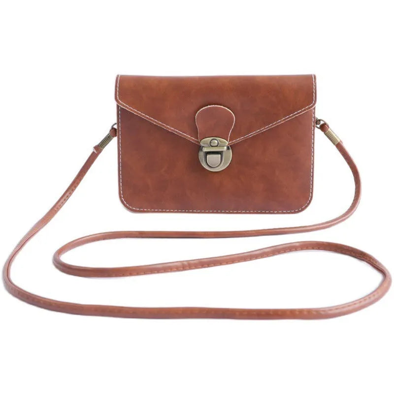 Soft surface PU messenger bag in wine red with a flap closure and metal lock detail.