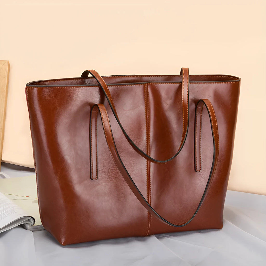 Women's soft cowhide leather shoulder bag in retro brown colour showing external slit pocket and single strap.