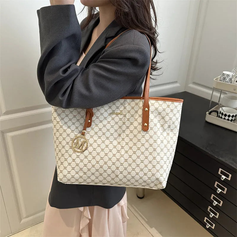 Soft PU leather ladies' shoulder bag in black showing contrast stitching and a top handle.