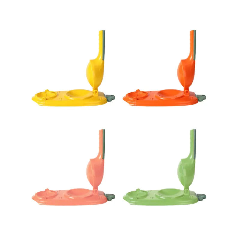 Orange and white plastic manual dumpling press tool with ergonomic handle on a kitchen worktop.
