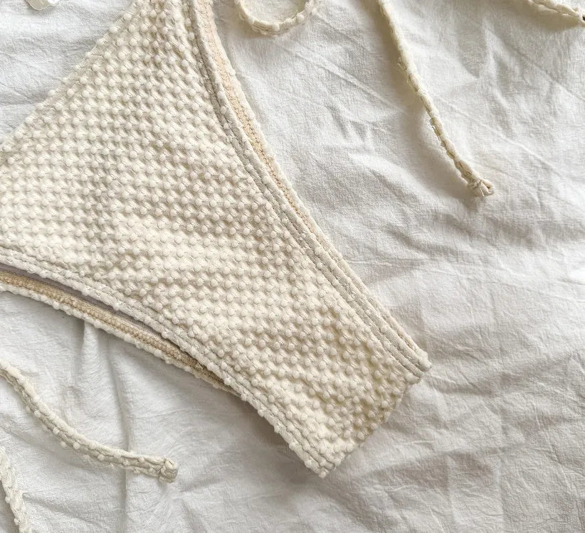 Women's white halter lace-up bikini swimsuit with briefs bottom for beach use