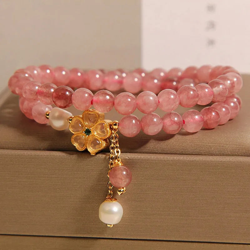 Women's double ring bracelet with a strawberry quartz twin four-leaf clover design.