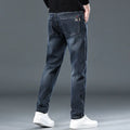 Man wearing slim straight blue-grey casual trousers with a micro-elastic waist for street fashion summer wear.