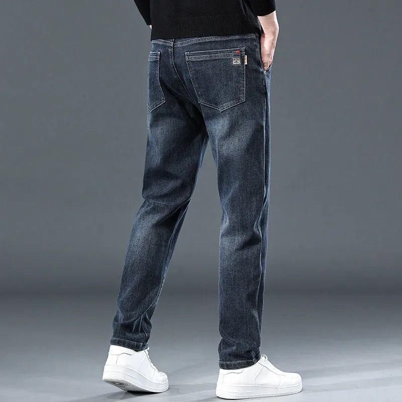 Man wearing slim straight blue-grey casual trousers with a micro-elastic waist for street fashion summer wear.