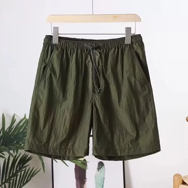 Men's straight-leg quick-dry sports shorts in army green on a plain background.