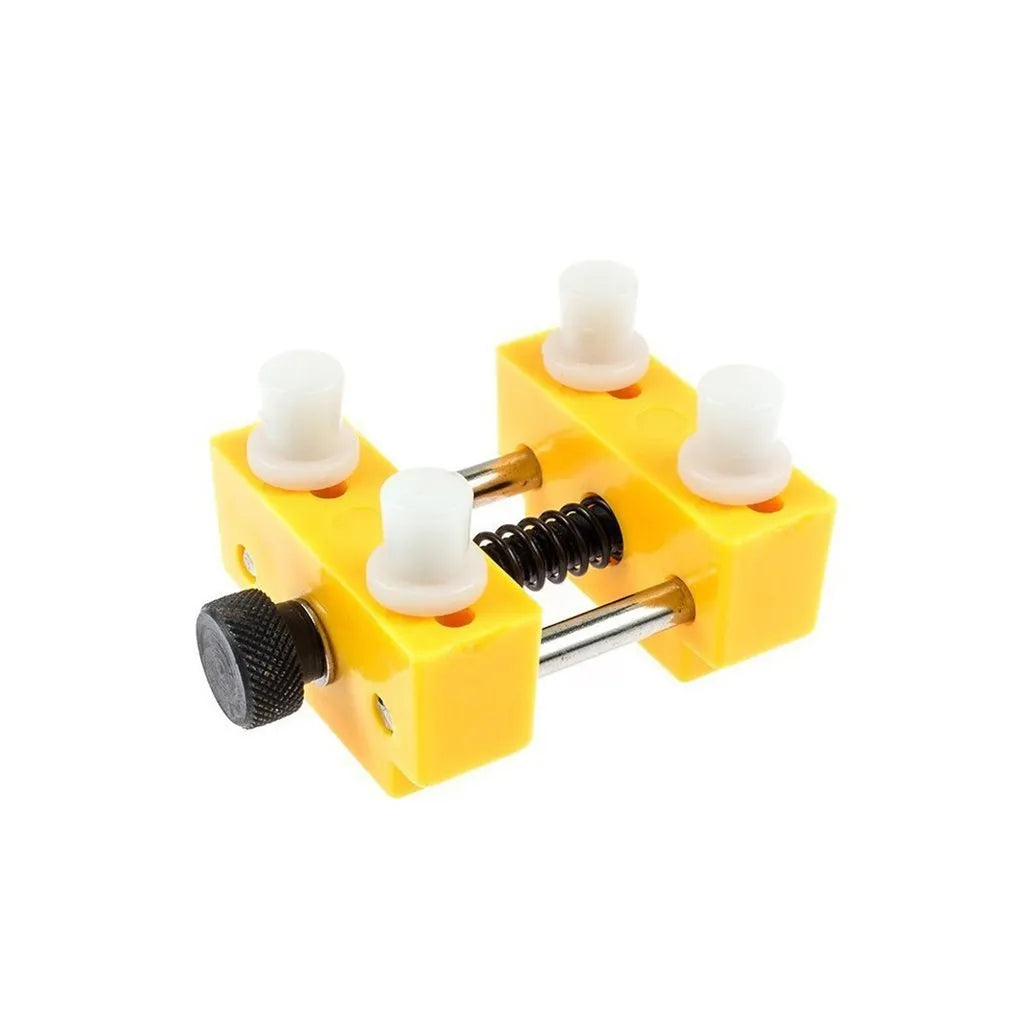 Yellow plastic watch repair case opener kit with mounting base and four positioning pillars