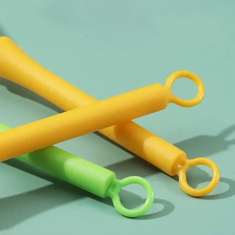 Plastic creative mini manual eggbeater in green and yellow, size 4x18.5 cm, on kitchen counter