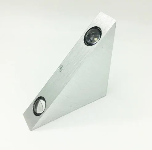 Set of three white LED wall lights with dual heads mounted on a wall showing warm white light
