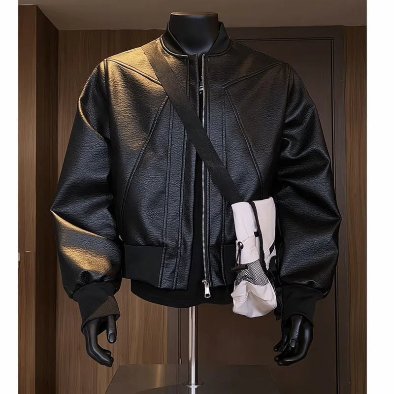 Man wearing a black slim-fit PU leather jacket with litchi grain texture and extended length.